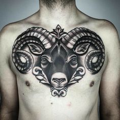 a man with a goat head tattoo on his chest