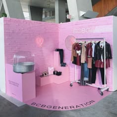 a pink booth with clothes on display in it