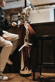 a person sitting on a bench with a wine bottle wrapped around it's neck