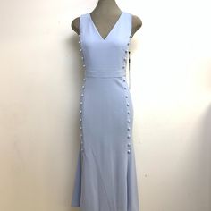 Elevate Your Wardrobe With This Stunning Calvin Klein Elegant Zen Light Blue Color, V-Neck Button Crepe Fit & Flare Dress In Size 6 And 12. This Dress Features A Flattering Front Button Sides Decoration Ending On Two Open Slits, A V-Neckline, Sleeveless Design, And A Zip Closure. The Crepe Fabric Gives It A Structured And Luxurious Feel, While The High Quality Poly/Spandex Material Ensures Comfort And Ease Of Movement. The Dress Comes In A Beautiful Blue Color And Features A Bohemian Theme, Perf Fitted V-neck Dress With Buttons For Spring, Calvin Klein Summer V-neck Midi Dress, Light Blue Sleeveless Dress With Buttons, Blue V-neck Midi Dress With Buttons, Spring Fitted V-neck Dress With Buttons, Spring Calvin Klein Dress With Button Closure, Calvin Klein Spring Dresses With Button Closure, Chic Calvin Klein V-neck Midi Dress, Chic Calvin Klein Midi Dress With V-neck