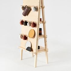 a wooden shelf with cups and mugs mounted to it's sides on the wall