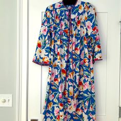 Nwot Vintage House Coat With Zipper 3/4 Length And 2 Side Pockets In A Beautiful Blue Floral Print With Lavender Satin Trim. Size: Medium Fabric: Polyester Long Sleeve Floral Print Nightgown For Spring, Blue Floral Print Sleepwear For Home, Blue Spring Robe For Loungewear, Blue Floral Print Long Sleeve Sleepwear, Blue Long Sleeve Sleep Robe, Blue Nightgown For Spring Loungewear, Blue Long Sleeve Robe For Sleep, Long Sleeve Blue Nightgown For Home, Blue Long Sleeve Sleepwear For Vacation