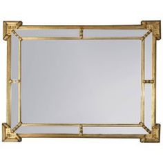 a gold framed mirror on a white background