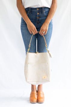 Birch White Leather Carryall & Crossbody – Meanwhile Back on the Farm On-the-go Satchel Shoulder Bag With Brass Hardware, Modern Bucket Shoulder Bag With Brass Hardware, Rectangular Hobo Bag With Brass Hardware For Travel, Daily Beige Bags With Brass Hardware, Beige Bags With Brass Hardware For Daily Use, Chic Satchel With Brass Hardware For Everyday Use, Everyday Leather Handle Crossbody Bucket Bag, Leather Handles Crossbody Bucket Bag, Leather Handles Crossbody Bucket Bag For Everyday Use