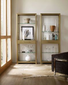 a living room filled with lots of furniture and shelves covered in vases on top of them