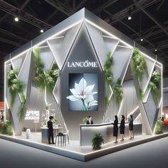 an exhibit booth with people standing around and looking at items on the display wall that says lancome