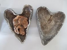 two heart shaped metal objects sitting next to each other