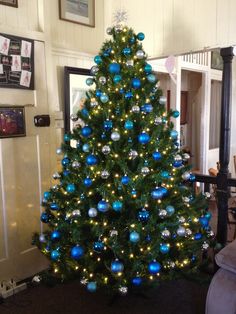 a christmas tree with blue and silver ornaments