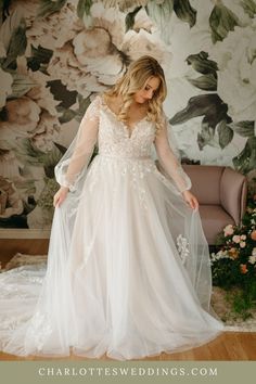 a woman in a wedding dress is standing on the floor