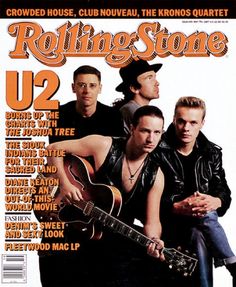 the rolling stone magazine cover with two men holding an acoustic guitar and one man wearing a cowboy hat