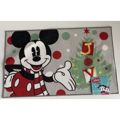 a mickey mouse rug with christmas tree on it