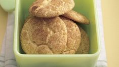 some cookies are in a green bowl on a table