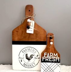 two wooden cutting boards with tags attached to them