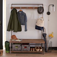 a coat rack with clothes and shoes on it