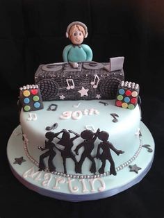 a birthday cake decorated with musical instruments and people