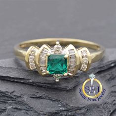 "Restored Vintage Princess Cut Emerald and Diamond Ring, Solid Yellow Gold. Product Highlights: METAL: Solid Yellow Gold, Stamped 10K GEMS: 1 Lab Emerald-- 0.41 ct              18 Natural Diamonds-- 0.33 ctw CURRENT SIZE: 10.  (Expert resizing service available. Safe resize range for this ring: 6 1/2--10. See below to purchase resizing.) APPRAISED VALUE: $1,570 This ring's princess-cut lab created emerald is a rich, vibrant green, and is surrounded by a unique and elegantly tiered halo of natura Classic Gia Certified Diamond Ring For May Birthstone, Gia Certified Classic Diamond Ring For May Birthstone, Vintage Emerald Ring With Vvs Diamond, Classic Cluster Emerald Diamond Ring, Classic Diamond Ring With Vvs Clarity For May Birthstone, Classic Diamond Cluster Ring For May Birthstone, Heirloom Emerald Ring Gia Certified For Anniversary, Classic Emerald Cluster Ring With Diamond Accents, Classic Diamond Ring With May Birthstone Accents