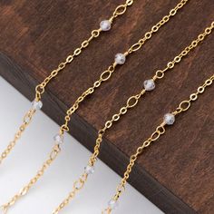 Color: see picture Size: quartz bead 3mm, chain 1.7mm approx. Material: 18K real gold plated on brass chain, quartz stone beads Quantity: 1 meter=3.3 feet Custom item service available, bulk quantity wholesale is welcome. ❤ Other finish of this chain(gold/rhodium/ raw brass etc.): ❤ https://www.etsy.com/shop/nbeads/?search_query=LK-221 ❤ See more chains here: ❤ https://www.etsy.com/shop/Nbeads?ref=hdr_shop_menu&search_query=LK Adjustable Gold Beaded Necklace With Satellite Chain, Gold Beaded Necklace With Satellite Chain, Gold Beaded Glasses Chains, Gold Chain Necklace With Faceted Beads For Gift, Diy Chain, Cross Chain, Crystal Chain, Quartz Beads, Chain Gold