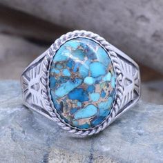 Sterling silver, good weight, cast mens ring with an Eagle on each side with an oval Genuine Turquoise with Copper incursions. Top measures approximately 3/4" long X 1/2" wideMade out of sterling silver by our Jewelry artisan.Material: Sterling Silver 925Front width: 18mmSize see drop-down menu for availabilityStamped "925"Comes with jewelry boxready to ship*Resizing is not available for inlaid rings. Luxury Men's Polished Turquoise Ring, Luxury Polished Turquoise Men's Ring, Artisan Silver Turquoise Ring Untreated, Western Style Oval Turquoise Inlay Ring, Western Style Oval Turquoise Ring With Inlay, Western Oval Turquoise Ring With Inlay, Artisan Oval Turquoise Ring, Western Style Oval Rings For Gift, Oval Sterling Silver Rings With Patina