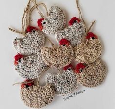 several crocheted ornaments are arranged in the shape of chickens, with red beaks