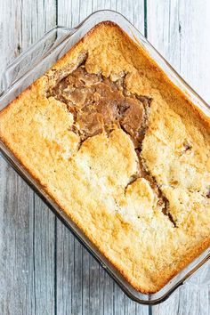 a baked dessert in a glass dish on top of a wooden table