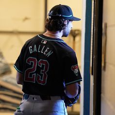 a baseball player is standing in the dugout