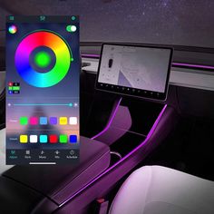 the interior of a car with an electronic device in it's center console and colorful lights on the dashboard