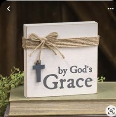 a small wooden box with a cross on it and the words, by god's grace