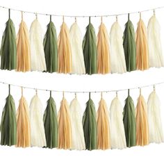 two rows of tassels hanging on a line with white and green fringes