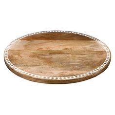 a wooden tray with white dots on the edge and an oval design in the middle