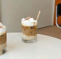 two drinks sitting on top of a white table