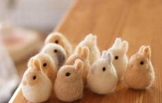 small stuffed animals sitting on top of a wooden table