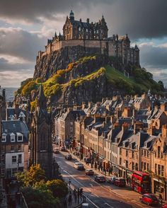 an old castle on top of a hill in the middle of town