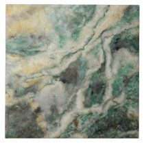 green marble textured with white and yellow streaks on the top right hand corner, showing dark brown spots in the middle