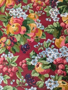 a red floral print fabric with blue, yellow and pink flowers on it's sides