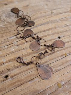 Rustic Antiqued Copper Dangle Teardrop Charm Bracelet and Earrings, Fun Rustic Copper Jangle Bracelet, Adjustable What a fun rustic bracelet! I hung these rustic copper (plated steel) teardrops in pairs (back to back) from a length of antiqued copper open circle link chain. Designed to be adjustable--Connect the clasp at your comfort point. Designed with a gothic, Steampunk vibe--teardrops vary in oxidation.  Tip to Tip bracelet as shown measures 8.5 inches. The extra rings are designed to dangle. I can shorter/lengthen as you desire. These equally rustic earrings feature the same copper teardrops falling from an 8mm copper ring and the earwires of your preference. Add on for a full set! Earrings fall 1.75" from the top of the hook earwires as shown in these pictures. REPEAT CUSTOMERS: Don Adjustable Teardrop Copper Jewelry, Adjustable Copper Teardrop Jewelry, Rustic Bracelet, Copper Bracelets, Rustic Earrings, Gothic Steampunk, Copper Rings, Copper Bracelet, Copper Chain