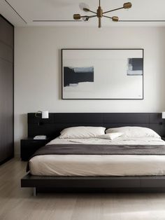 a large bed sitting in the middle of a bedroom next to a painting on the wall