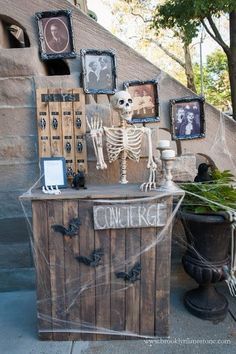 a halloween display with skeleton decorations and pictures on the wall