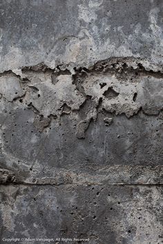 an old cement wall with cracks in it