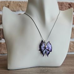 Elevate your style with this exquisite purple butterfly necklace, meticulously crafted to capture the delicate beauty and intricate details of a butterfly's wings. The shimmering purple hues and textured wing patterns make this necklace the perfect piece to add elegance and glamor to any outfit. Whether you're dressing for a special occasion or adding a unique accessory to your everyday look, this butterfly necklace is designed to make you feel extraordinary. Each piece is crafted with precision Butterfly Pendant Necklace, Purple Butterfly, Butterfly Necklace, Butterfly Pendant, Butterfly Wings, Handmade Accessories, Accessories Unique, Glass Pendants, Silver Color