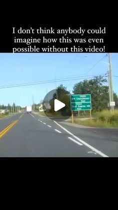 a car driving down the road next to a street sign and traffic light with words on it