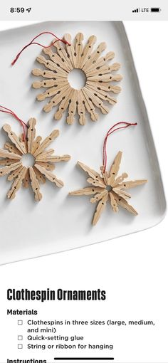 three wooden snowflakes on a white plate with red string hanging from the top