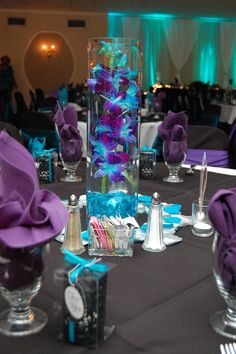 the centerpieces are decorated with purple and blue flowers