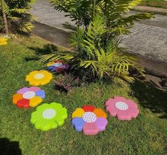 colorful flower shaped lawn decorations in the grass