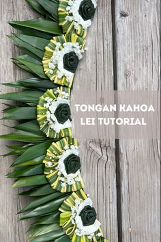 an arrangement of flowers and leaves on a wooden surface