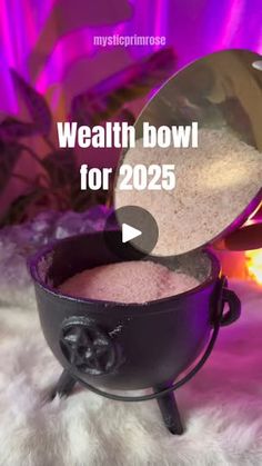 a bowl filled with sand sitting on top of a white fur covered floor