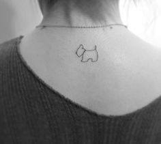 a small dog tattoo on the back of a woman's neck is shown in black and white