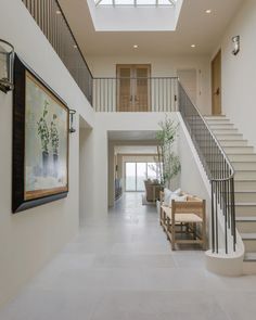 an open floor plan with white walls and stairs