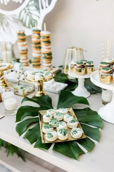 a table topped with lots of desserts and cupcakes