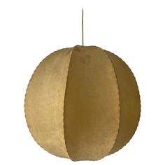 a round light fixture hanging from a white ceiling with a brown paper ball on it