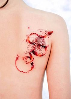 a woman's back with a tattoo on her shoulder and an octopus in the middle